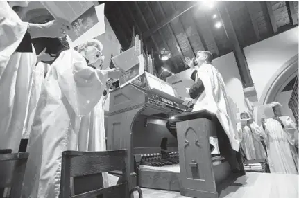  ?? KENNETH K. LAM/BALTIMORE SUN ?? Music director Daniel Aune directs the choir at Christ Lutheran Church. Aune is also president of the Baltimore chapter of the American Guild of Organists, which recently reported that about 60 percent of its 16,000 members were 58 years of age or older.