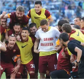  ?? Photo: AP ?? Roma's Francesco Totti, centre, wears a jersey reading in Italian ‘La Grande Bellezza’ (The Great Beauty) as he celebrates with his teammates after yesterday’s 2-1 derby win against Lazio