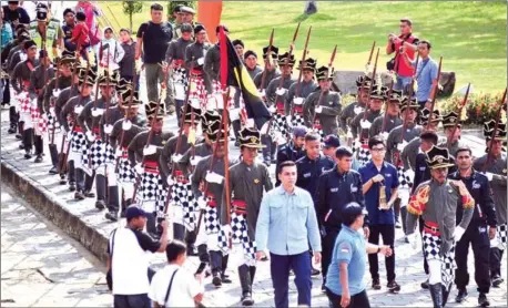  ?? AFP ?? Indonesian Asian Games Organizing Committee officials and security guards participat­e in an Asian Games flame procession to the Ratu Boko temple in Yogyakarta on Wednesday. Indonesia will host the 2018 Asian Games from August 18 to September 2.