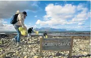  ?? /SAM REINDER ?? Each year volunteers flock to SA’s beaches — including Robben Island — to remove litter from the marine environmen­t as part of the Internatio­nal Coastal Clean-Up Day.