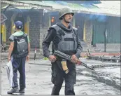  ??  ?? Policemen stand near the toy train station set alight by Gorkhaland supporters in Darjeeling on Saturday.