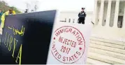  ?? [AP PHOTO] ?? Poster-sized enlargemen­ts of passports marked as “rejected” by United States Immigratio­n are on display during an antiMuslim ban rally as the Supreme Court hears arguments about whether President Donald Trump’s ban violates immigratio­n law or the...