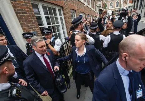  ?? Getty Images ?? Above, Labour Party leader Keir Starmer is led past protesters in London after giving a speech on the crisis in Gaza; below, his party has faced criticism for failing to call for a ceasefire in the enclave during the early stages of the war