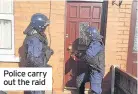  ??  ?? Police carry out the raid