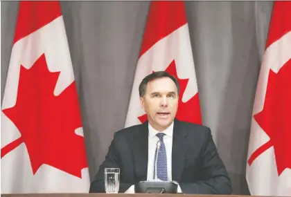  ?? DAVE CHAN/AFP VIA GETTY IMAGES ?? Canada’s Finance Minister Bill Morneau speaks during a news conference on Parliament Hill last week. The federal government is under pressure to deploy tens of billions of dollars to put companies — even entire industries — on life support while government­s effectivel­y power down non-essential elements of the global economy to stop the spread of COVID-19, Kevin Carmichael writes.