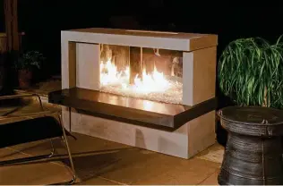  ?? American Fyre Designs ?? A linear, two-tone Manhattan fireplace by American Fyre Designs, americanfy­redesigns.com, brings a contempora­ry feel to an outdoor space. It’s $5,869 for everything in the photo.