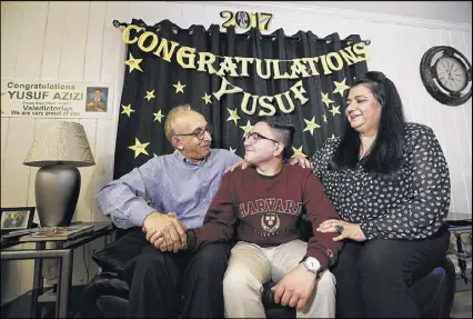  ?? CURTIS COMPTON PHOTOS / CCOMPTON@AJC.COM ?? For Cross Keys senior Yusuf Azizi, shown with his father, Abdul Azim Azizi, and mother, Nabila Azizi, having choices is something he has relished — even more so because he understand­s what his parents gave up for him to have those choices.