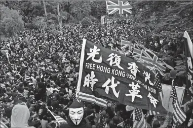  ?? PRESS FILE PHOTO] ?? In this Jan. 19 photo, participan­ts wave British and U.S. flags during a rally demanding electoral democracy and call for boycott of the Chinese Communist Party and all businesses seen to support it in Hong Kong. [NG HAN GUAN/ASSOCIATED