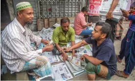  ?? Photograph: Monirul Alam/EPA ?? A newspaper seller in Dhaka, Bangladesh. Journalist unions called the decision a ‘reflection of the repression of opposition voices’.