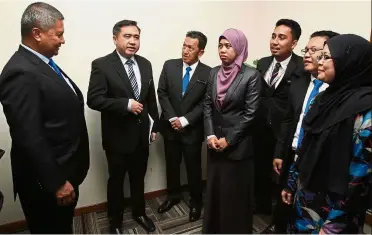  ??  ?? Working meet: Loke having a chat with staff of Railway Assets Corporatio­n (RAC) during his visit to their office in Kajang. Looking on is RAC board of directors chairman Datuk Seri Saripuddin Kasim (left).