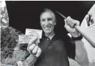  ?? Jeremy Papasso, Daily Camera ?? Bruce Kirschner, a former Boy Scout, holds his unused Woodstock concert tickets from 1969 at his home in Louisville.