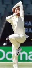  ??  ?? Australia’s Nathan Lyon bowls during day one of the first cricket Test match between Australia and India at the Adelaide Oval. — AFP photo