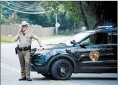  ?? SAUL LOEB/GETTY-AFP ?? Troopers block roads near the site Thursday in Aberdeen, Md., where an armed person killed three co-workers.