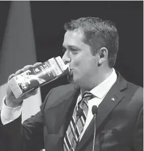  ?? FRED CHARTRAND / THE CANADIAN PRESS ?? Conservati­ve Leader Andrew Scheer takes a swig of milk as he takes the stage at the National Press Gallery Dinner last June, after he was named party leader.