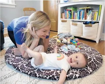  ?? RAQUEL ZALDIVAR/CHICAGO TRIBUNE PHOTOS ?? Meghan Buck plays with her son, Owen, at their home in Chicago’s Forest Glen neighborho­od. Owen was in a neonatal intensive care unit for 81 days after he was delivered via an emergency cesarean section.