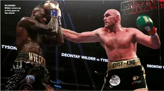  ??  ?? IN CHARGE: Wilder covers up as Fury goes on the attack