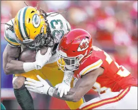  ?? Charlie Riedel
The Associated Press ?? Green Bay Packers running back Aaron Jones is hit by Chiefs cornerback L’jarius Sneed during the first half of Kansas City’s 13-7 victory on Sunday at Arrowhead Stadium.