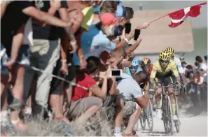  ?? (AFP) ?? Team Jumbo rider Slovenia’s Primoz Roglic wearing the overall leader’s yellow jersey leads his group on the Glieres plateau during the 18th stage of the 107th edition of the Tour de France, 168 km between Meribel and La Roche sur Foron, on Thursday.