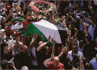  ?? Mahmoud Illean / Associated Press ?? Family, friends and colleagues of Al Jazeera journalist Shireen Abu Akleh carry her coffin to a hospital in East Jerusalem. She was shot dead during an Israeli military raid in the West Bank.