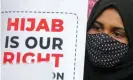  ?? Anushree Fadnavis/Reuters ?? A Muslim student holds a placard during a protest by Muslim Students Federation (MSF) against the hijab ban. Photograph: