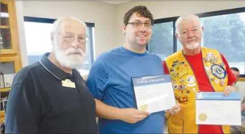  ?? Westside Eagle Observer/SUSAN HOLLAND ?? Jeff Davis (left), president of the Gravette Lions Club, poses with Tylar Lee and his sponsor Al Blair after the ceremony to induct Tyler as a new member of the club. Tylar displays his membership certificat­e and Al his sponsor’s certificat­e. Tylar is the new pastor of the Gravette and the Decatur United Methodist churches.