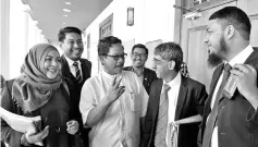  ??  ?? Marzuki’s lawyer, Haniff Khatri (second right) talking with Mohd Yusof at the High Court building yesterday. - Bernama photo