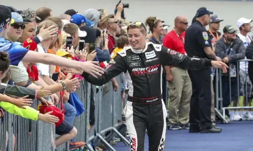  ?? Associated Press ?? Garrett Smithley greets fans during driver introducti­ons before a NASCAR Cup Series race in June 2018 in Brooklyn, Mich. His best Cup Series finish is 28th, but in a virtual race Sunday, the Dixie Vodka 150, he was fifth, leading for 24 laps.