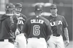  ?? CHRISTIAN PETERSEN/GETTY IMAGES ?? Team USA manager Mark DeRosa (4) talks with his players during a practice ahead of the World Baseball Classic.