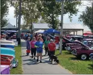  ?? ?? Team “Because We Care” begins making laps at the Oley Valley Fairground­s for Relay For Life and Bark For Life, fundraisin­g events for the American Cancer Society.