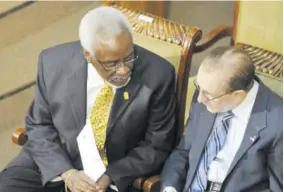  ??  ?? Former Prime Minister P J Patterson (left) has a word with former Prime Minister Edward Seaga in Parliament on March 28, 2006 when the House had a special sitting to bid farewell to Patterson after his 30 years of political service.