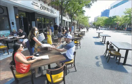  ?? Matthew Brown / Hearst Connecticu­t Media ?? Area restaurant­s begin to transform Bedford Street in Stamford into outdoor “streaterie­s” on May 30. Below, La Taqueria owner Dennis Lake in his restaurant at 10 Greenwich Ave. in Greenwich on Wednesday.