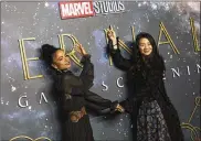  ?? INVISION/AP PHOTO BY VIANNEY LE CAER/ ?? Lauren Ridloff, left, and director Chloe Zhao pose for photograph­ers upon arrival at the premiere of the film ‘Eternals’ on Oct. 27 in London.