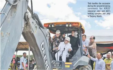  ??  ?? Taib handles the excavator during the ground-breaking ceremony for KRIS’ industrial sites and AIC’s bulking complex and jetty in Tanjong Manis.