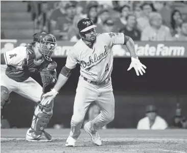  ?? GREGORY BULL/ASSOCIATED PRESS ?? Coco Crisp knocks in two runs for the A’s with a single in the sixth inning Saturday. Crisp also had two doubles and a walk and scored in each of his first four trips to the plate.