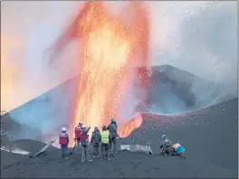  ?? TANER ORRIBO — THE ASSOCIATED PRESS ?? Scientists from the Spanish National Research Council take geophysics measuremen­ts on the Canary Island of La Palma, Spain, on Saturday.