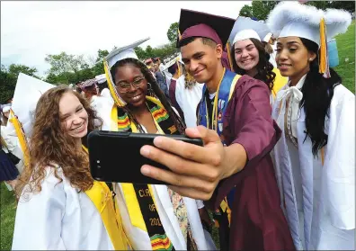  ?? File photos by Ernest A. Brown ?? Woonsocket High School graduates celebrate during last year’s commenceme­nt ceremonies. The Woonsocket School Committee will be asked to approve a plan to hold this year’s graduation through an online platform.