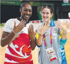  ?? Picture: GETTY IMAGES ?? Volunteer photograph­er Erin Aumann and England basketball­er Melita Emanuel-Carr compare painted nails.