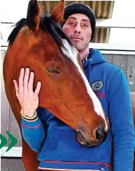  ??  ?? Horse whisperer: Dragos’s gentle touch sends the feisty Ask A Honey Bee to sleep