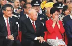  ?? AP ?? Hong Kong chief executive Carrie Lam (right) former chief executive Tung Chee-hwa (centre) and former chief executive Leung Chun-ying attend the flag raising ceremony.