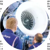  ??  ?? Technician­s check a Rolls-Royce Trent engine used in Dreamliner aircraft.