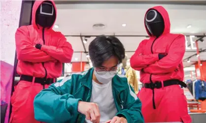  ?? Photograph: Chalinee Thirasupa/Reuters ?? A man participat­es in a Netflix series Squid Game mission at a store in Bangkok, Thailand. The series is a South Korean survival drama.