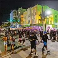  ?? D.A. VARELA/MIAMI HERALD VIA AP ?? Crowds walk up and down Ocean Drive during spring break on Saturday in Miami Beach, Fla.