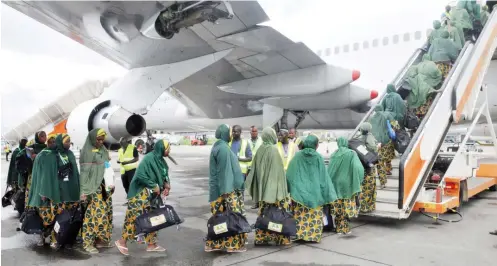  ??  ?? Pilgrims boarding an aircraft during the inaugural flight from Lagos State yesterday. PHOTO: