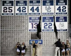  ?? Associated Press file photo ?? Connecticu­t basketball alumni Worthy Patterson and Bill Corley’s numbers are unveiled after the two were inducted into the Huskies of Honor during halftime of Connecticu­t’s NCAA basketball game against DePaul in Storrs on Feb. 15, 2012.