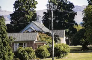  ?? PHOTO: MICHAEL CURREEN ?? Original planting . . . The Lawson cypress trees next to the Lumsden Presbyteri­an Church.