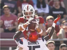  ?? Ezra Shaw / Getty Images ?? Stanford’s Simi Fehoko makes one of his two touchdown grabs despite the coverage of Arizona’s McKenzie Barnes.