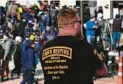  ?? PAUL SANCYA/AP 2021 ?? A person wearing an Oath Keepers T-shirt stands outside a courthouse in Wisconsin.
