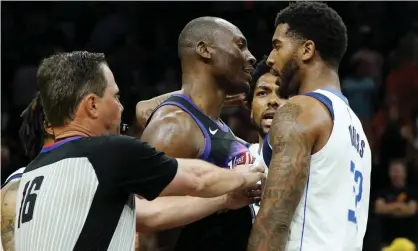  ?? Photograph: Ross D Franklin/AP ?? Referee David Guthrie tries to separate Phoenix Suns center Bismack Biyombo, middle, and Dallas Mavericks forward Marquese Chriss, right, before the pair were ejected.