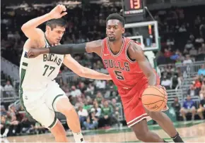  ?? MICHAEL SEARS / MILWAUKEE JOURNAL SENTINEL ?? Ersan Ilyasova tries to stay in front of Chicago’s Bobby Portis on Wednesday night. Ilyasova was part of a balanced offensive attack and finished with nine points.