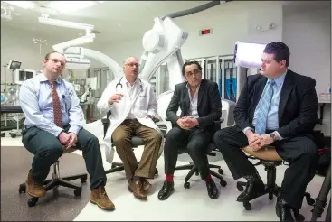  ?? NWA Democrat-Gazette/BEN GOFF @NWABENGOFF ?? Dr. Anton Cherney (from left), cardiothor­acic surgeon; Dr. Lance Weathers, interventi­onal cardiologi­st; Dr. Amr El-Shafei, interventi­onal cardiologi­st; and Dr. Matthew Parmley, cardiothor­acic surgeon, talk Feb. 28 during a press event about Mercy’s new...